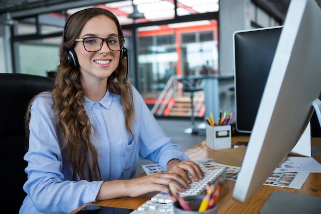 Female graphic designer working over computer at desk