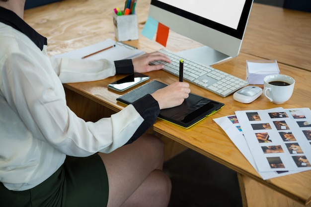 Female graphic designer working at desk