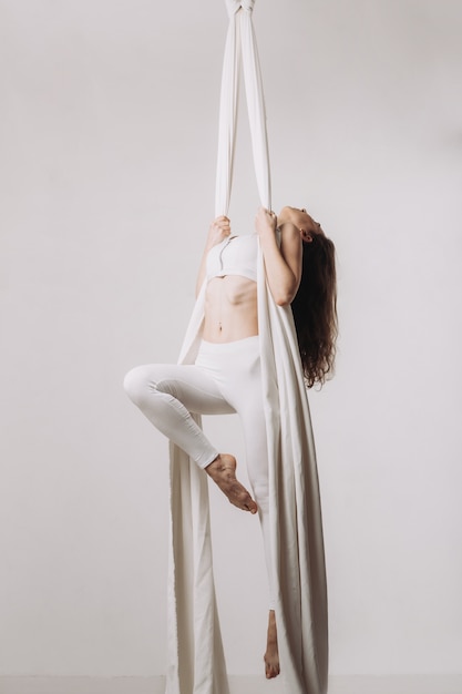 Female gymnast doing aerial silk acrobatics