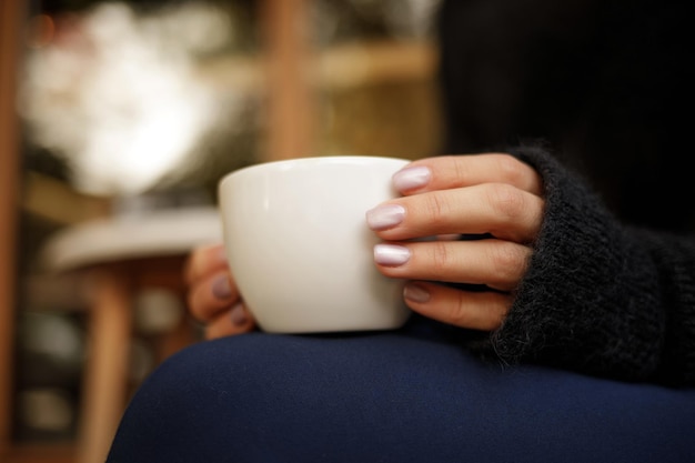 Female hand hold hot coffee cup