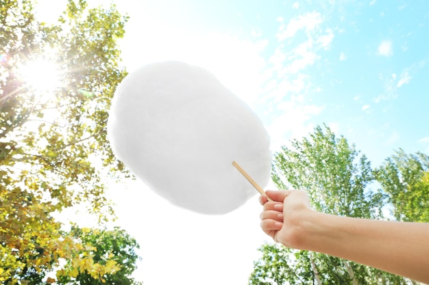 Female hand holding cotton candy outdoor