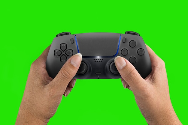 Female hand holding a Next Generation black game controller isolated on green screen background. Chroma Key.