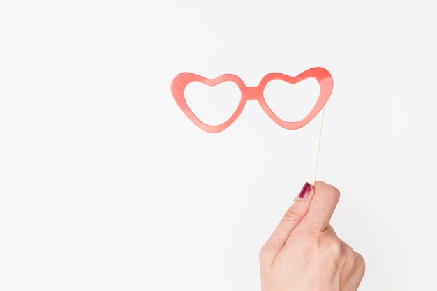 Female hand holding glasses photo booth prop