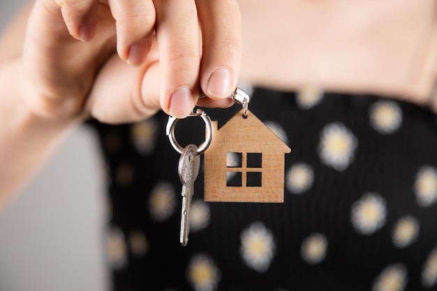 Female hand holding a house keychain