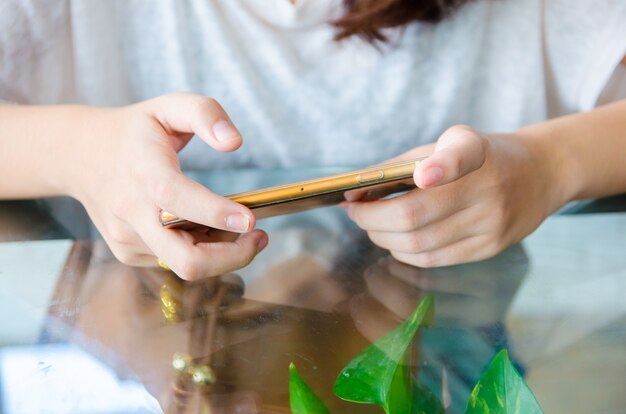 Female hand holding phone for play game