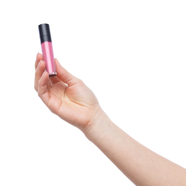 Female hand holding pink matt lipstick on white background