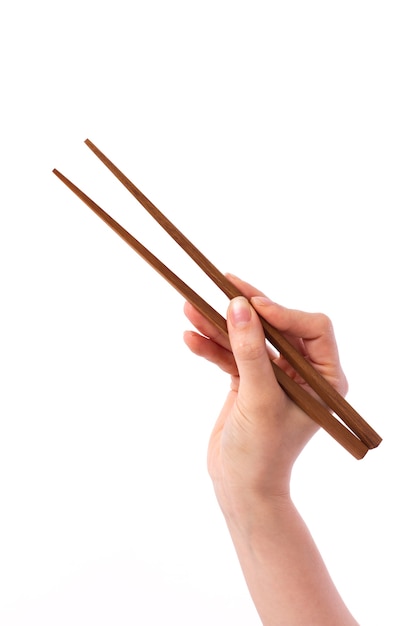 Female hand holding wooden chopsticks