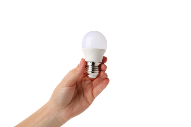 Female hand holds energy saving bulb, isolated on white background.