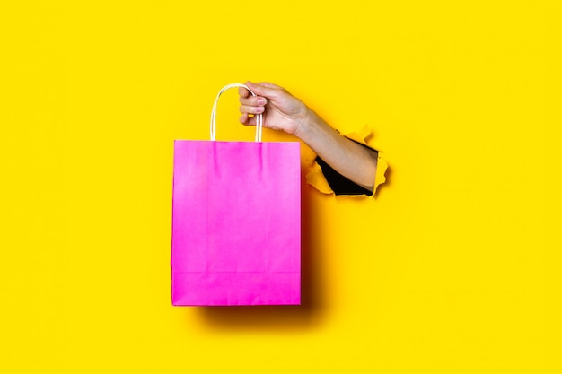 Female hand holds a pink package