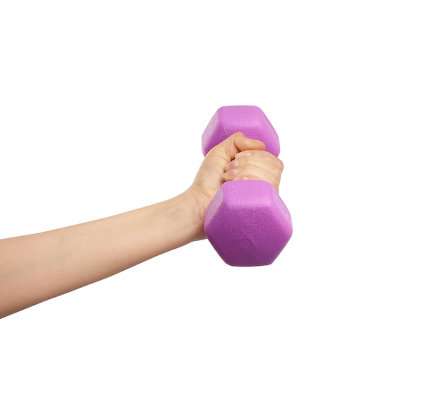 Female hand holds a plastic pink dumbbell on a white isolated background, sport concept