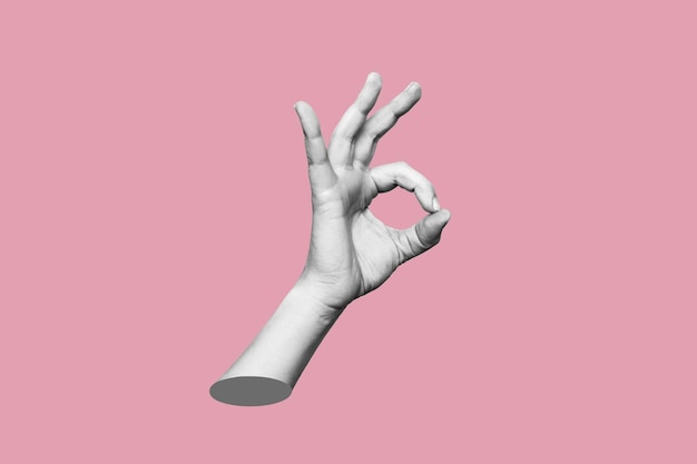 Photo female hand showing ok gesture isolated on pink color background contemporary art modern design