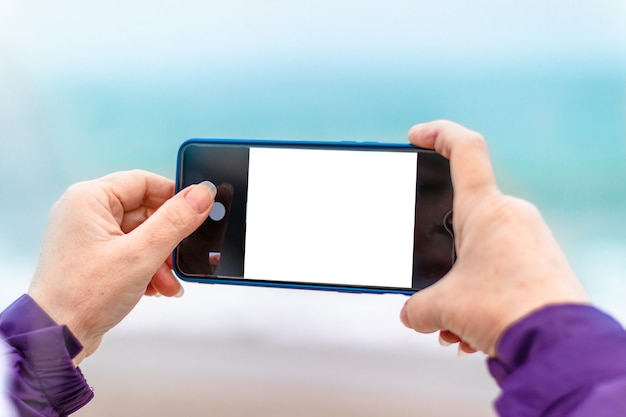 Female hand touching the screen of a smartphone