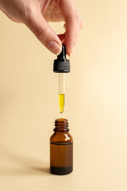 Female hand with Dropper of essential oil