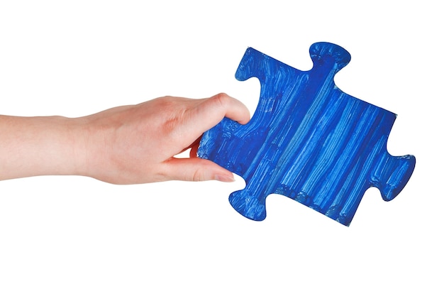 Female hand with painted blue puzzle piece