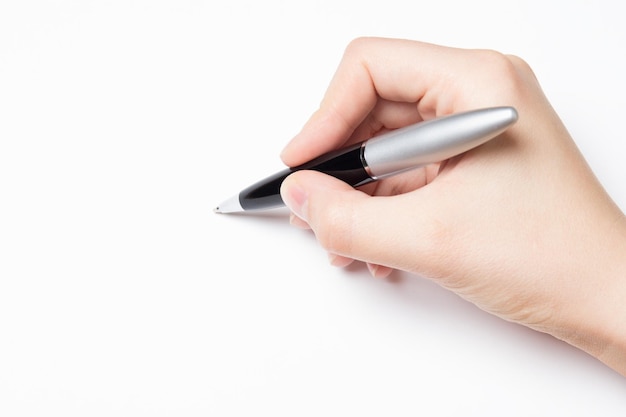 female hand with pen over white background