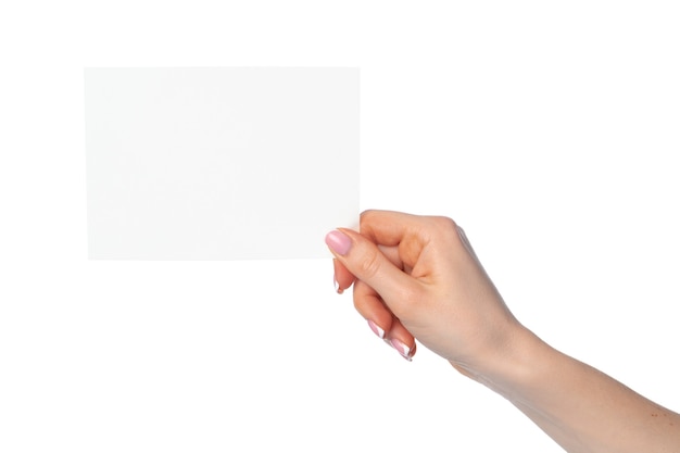 Female hand with white sheet of paper isolated on white