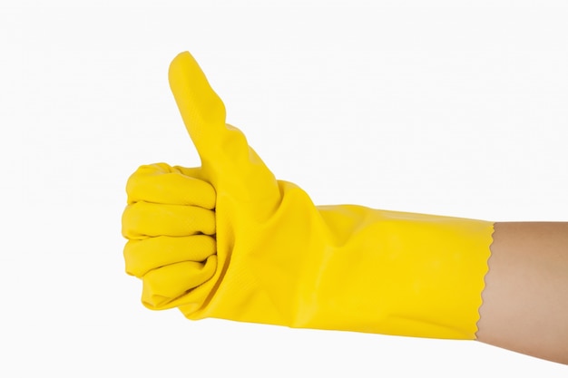 Female hand in yellow glove giving the thumbs up 