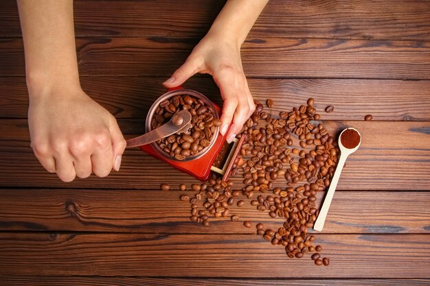 A female  hands and coffee grinder