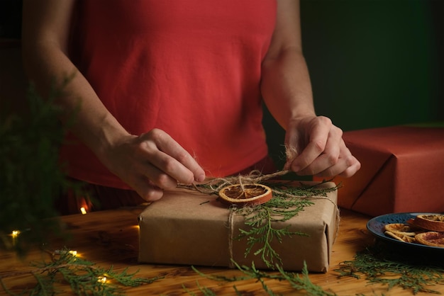 Female hands decorates Christmas present