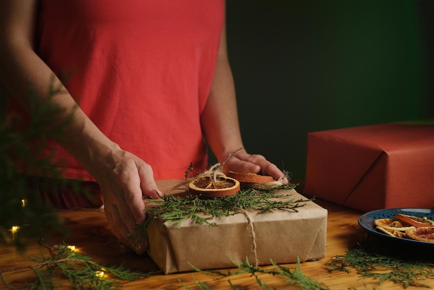 Female hands decorates Christmas present