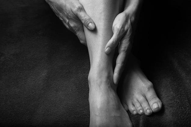 Female hands and feet portrait Woman with naked body Black and white portrait