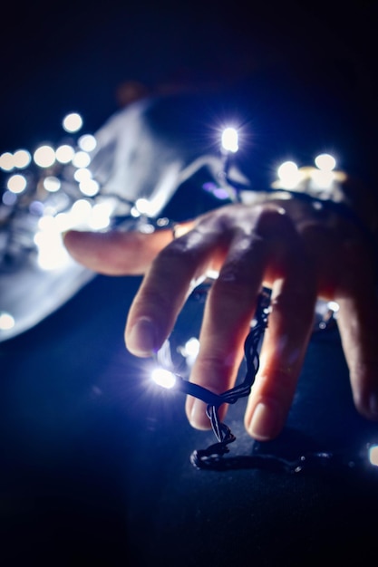 Female hands hold Christmas lights