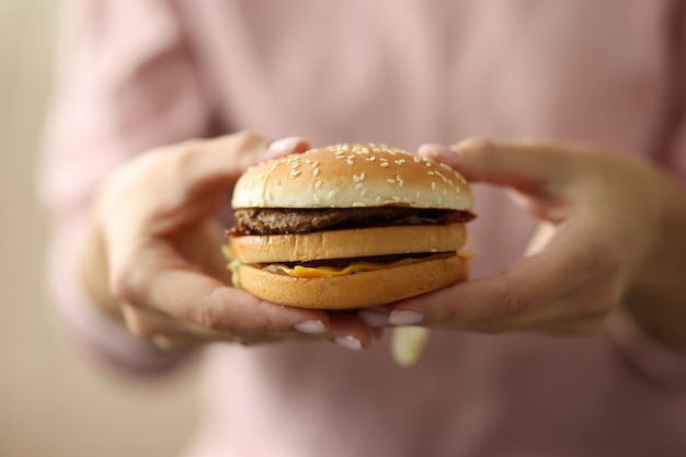 Female hands hold hamburger