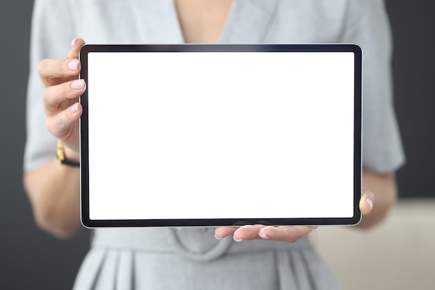 Female hands hold tablet with white screen online learning concept