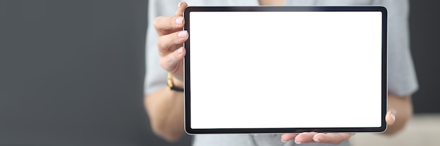 Female hands hold tablet with white screen online learning 