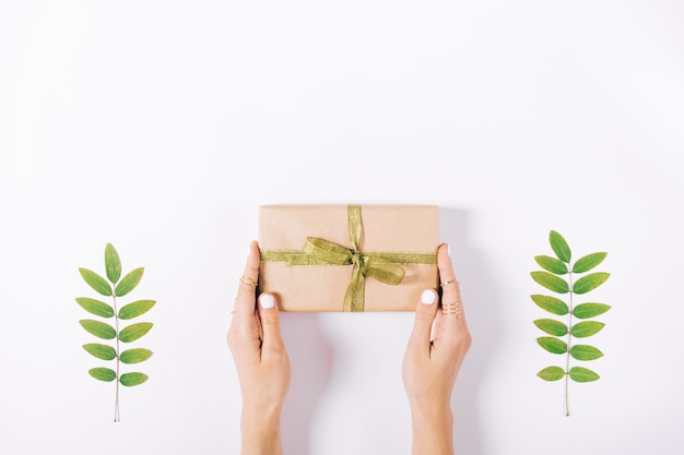 Female hands holding a box with a gift