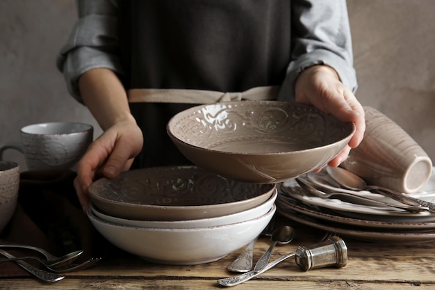 Female hands holding ceramic dishware closeup