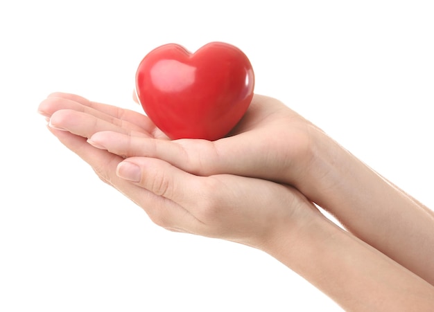 Female hands holding little ceramic heart on white background