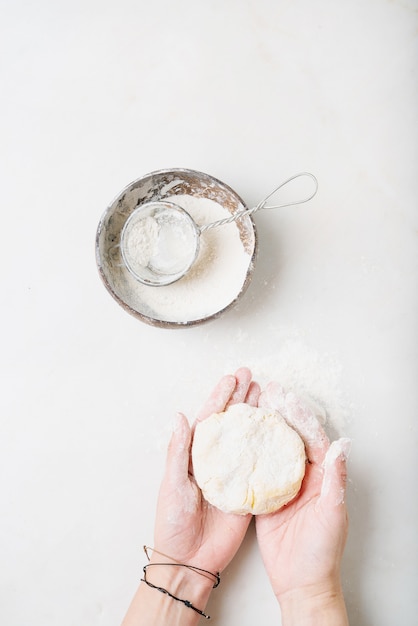 Female hands kneading the dough