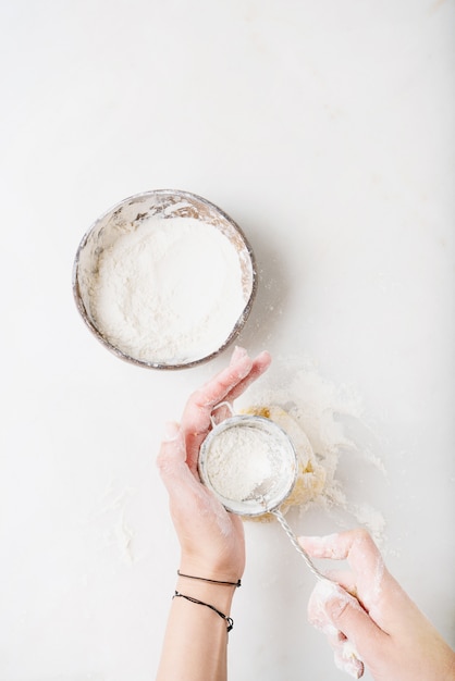 Female hands kneading the dough