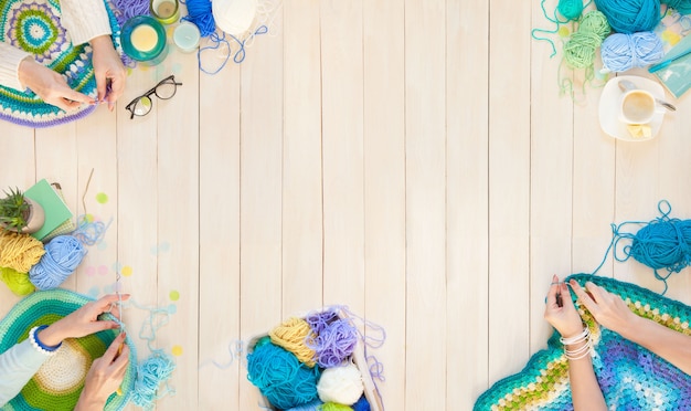 Female hands knitting with colorful wool