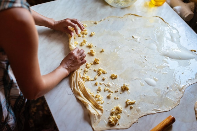 Female Hands Making Dough for baking Homemade Preparing Food Concept of the cooking process of baking homemade rolled borek pies