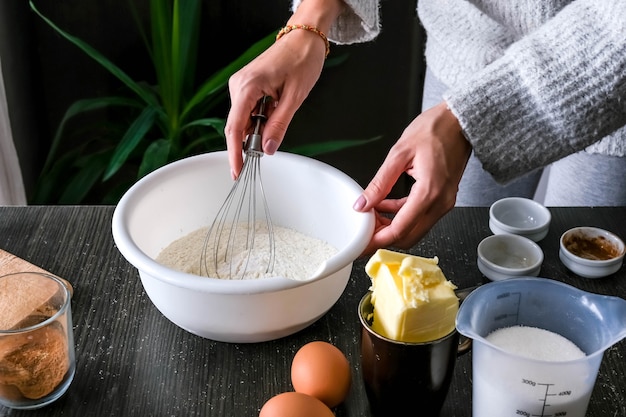 Female hands making dough for the cake