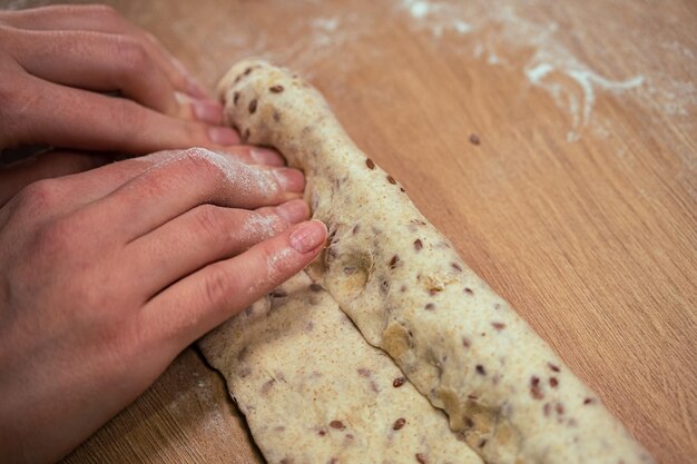 Female hands making a homemade baguette from whole grain flour healthy food