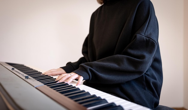 Female hands play musical keys soft focus