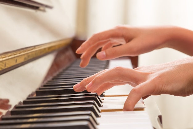 Female hands playing piano