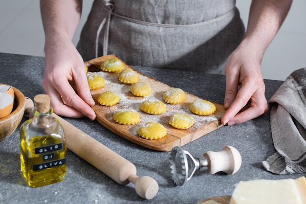 Female hands, process of preparation homemade italian pasta, ravioli - italian cuisine