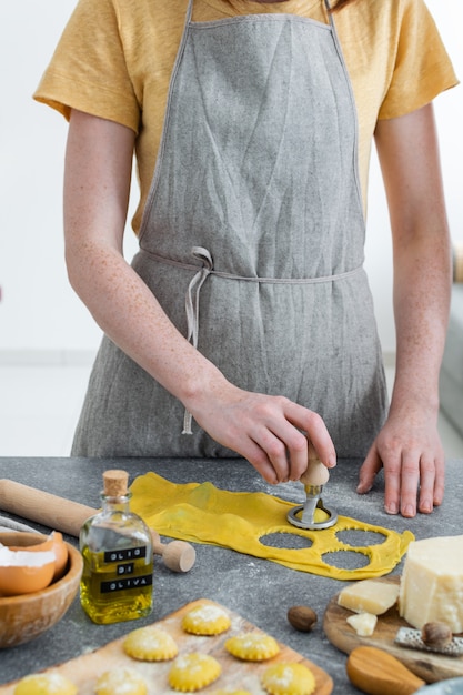 Female hands, process of preparation homemade italian pasta, ravioli