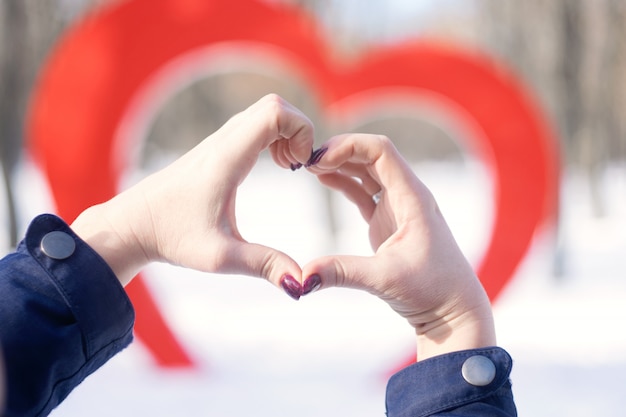 Female hands in the shape of heart