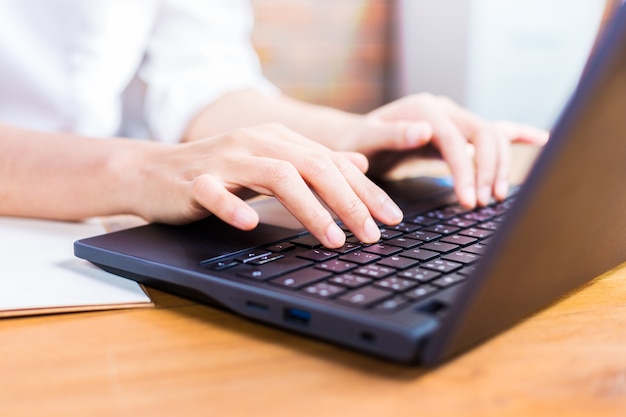 Female hands typing on her computer