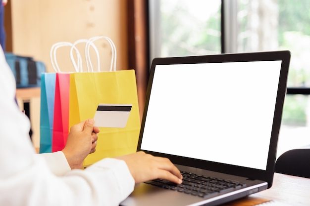 Female hands using laptop online shopping.