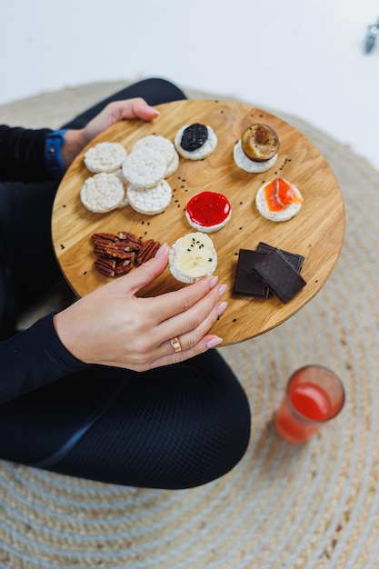 Female hands with bread Delicious dry breakfasts Fitness bread for a quick snack Rice cakes