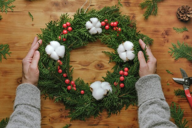 Female hands with Christmas wreath