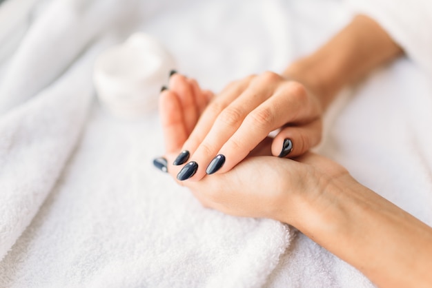 Female hands with cream closeup, skincare