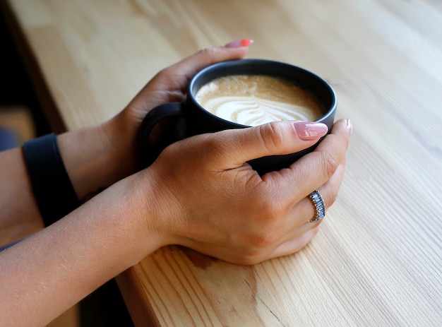 Female hands with cup of coffee