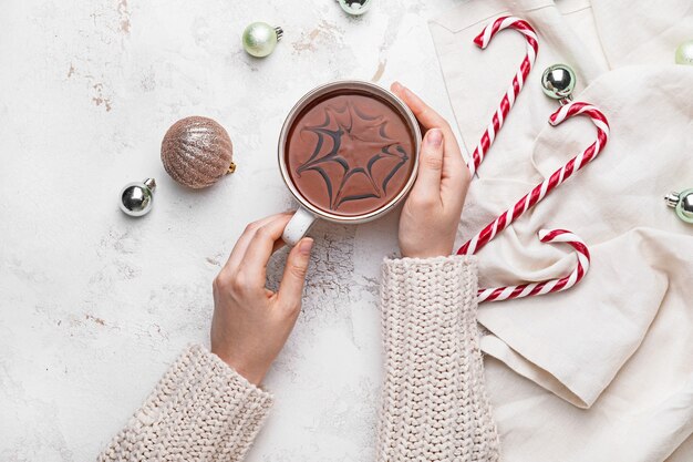 Photo female hands with cup of hot chocolate isolated